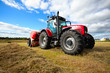 tractor collecting haystack in the field
