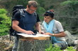 A couple with map and compass in the forest