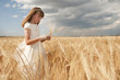 girl wearing first communion dress between barley