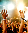 concert crowd in front of bright stage lights, rising arms concert crowd in front of bright stage lights, rising arms