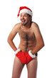 Sexy muscular man screams wearing a Santa Claus hat