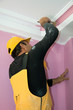 Photo: painting a wall pink by painters construction workers painting a wall pink by painters construction workers