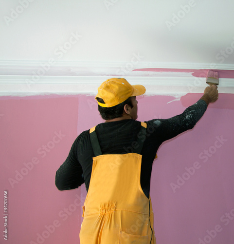 Photo: painting a wall pink by painters construction workers painting a wall pink by painters construction workers