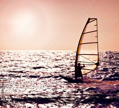 Photo: Windsurfer silhouette over sea sunset Windsurfer silhouette over sea sunset