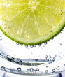 Closeup of lime slice with soda in glass
