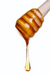 Photo: Honey dripping from a wooden dipper Honey dripping from a wooden dipper