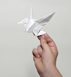 Origami crane in hand