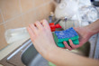 Washing of the dishes - woman hands rinsing dishes