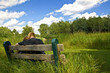 young couple cuddling on a park bench