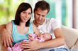 Photo: young couple with 7 week old baby young couple with 7 week old baby