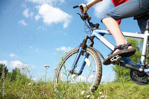 Photo: cyclist on green grass cyclist on green grass