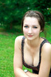 Portrait of thoughtful beautiful girl sitting in the green park Portrait of thoughtful beautiful girl sitting in the green park