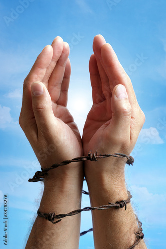 Photo: Hands tied with barbed wire Hands tied with barbed wire