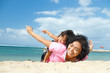 ethnic child fun with mother on tropical beach ethnic child fun with mother on tropical beach