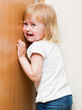Naughty child is standing in the corner