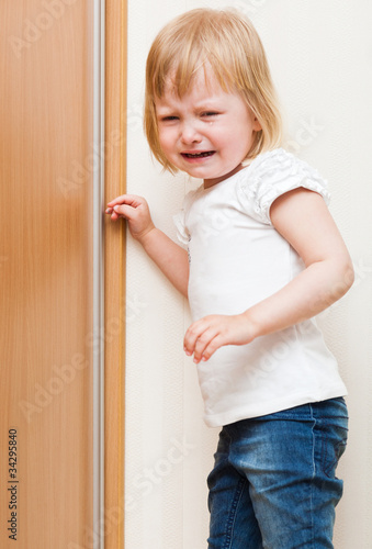Photo: Naughty child is standing in the corner Naughty child is standing in the corner