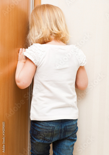 Photo: Naughty child is standing in the corner Naughty child is standing in the corner