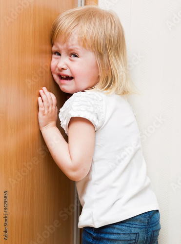 Photo: Naughty child is standing in the corner Naughty child is standing in the corner