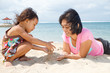 mother and child playing with beach sand mother and child playing with beach sand
