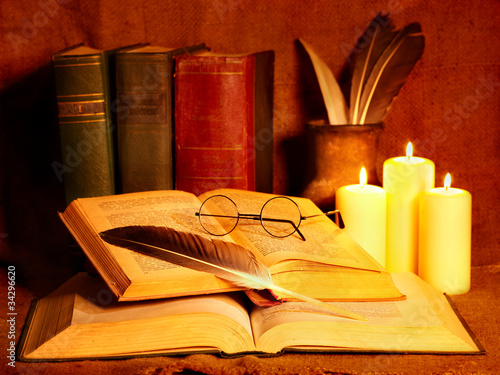 Photo: Stack old book and candle. Stack old book and candle.