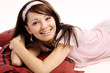 Happy young lady lying on the bed in pink underwear Happy young lady lying on the bed in pink underwear