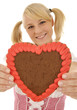 Foto: Junge Frau im Dirndl mit Lebkuchen-Herz Junge Frau im Dirndl mit Lebkuchen-Herz