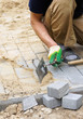 The worker paves a stone path