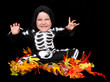Photo: adorable little boy dressed in scary skeleton costume. isolated adorable little boy dressed in scary skeleton costume. isolated