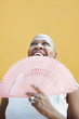Photo: mature african woman with fan, smiling mature african woman with fan, smiling