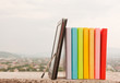 Row of colorful books with electronic book reader