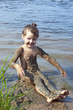 Baby girl in the mud on the river