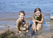 Children in the mud on the river