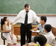 happy children learning with teacher in school