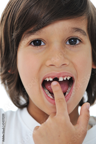 Photo: Lost milk tooth, cute boy with long hair Lost milk tooth, cute boy with long hair