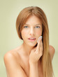 young blonde woman removing makeup