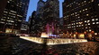Illuminated water fountain in front skyscrapers Illuminated water fountain in front skyscrapers
