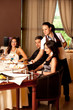 woman serving food restaurant table