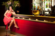 woman red dress at bar counter smiling woman red dress at bar counter smiling