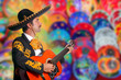 Charro Mariachi playing guitar over colorful blur Charro Mariachi playing guitar over colorful blur