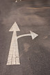 White arrow sign on grunge way