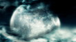 Heavy clouds revealing a bright shining full moon