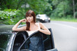 Young attractive brunette woman near car