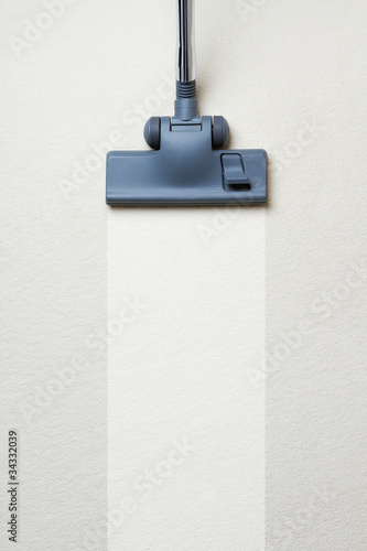 Photo: Vacuum cleaner on dirty carpet with copy space Vacuum cleaner on dirty carpet with copy space