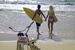 newlywed couple at the beach with surfboards and bikes