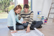 Man showing blueprint of their new house