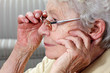 aged woman with glasses and hearing aid