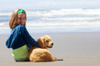child with a puppy at the beach