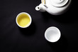 A tea pot and 2 cup of tea