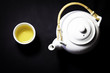 Tea pot and cup full of green tea