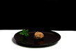 Chocolate Truffle on a Black Plate with Mint